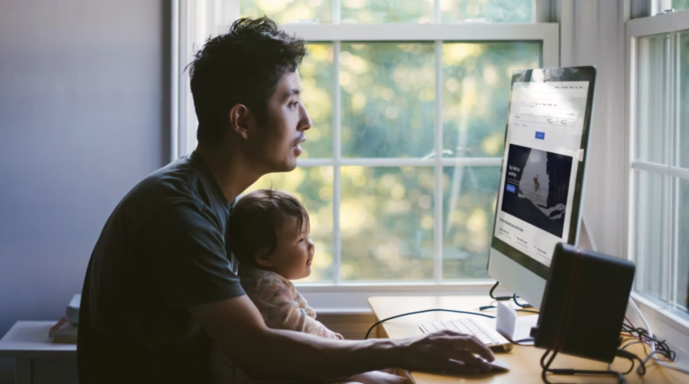 Man and baby researching vacations and trips